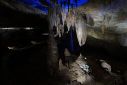 Blue illumination highlighting the stalactites in the Prometheus Cave