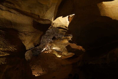 Illuminated rock formations and cave passages inside Cave of the Winds, Colorado, USA