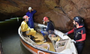 Boat with LED lighting on the underground river of Coves de Sant Josep