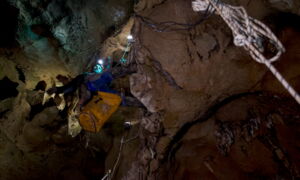 Installation team mounting LED technology inside the cave