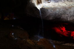 Red LED lighting on the rock wall in the Prometheus Cave