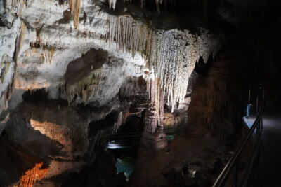 Illuminated cave lake with reflective water – sustainable LED systems for underground lighting
