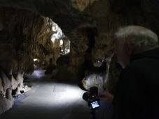 Visitor group on illuminated path through the Bilstein Cave