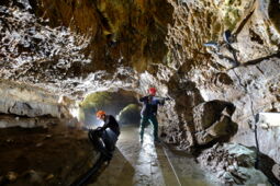 Technician installing LED lights on the rock wall of Baumann’s Cave